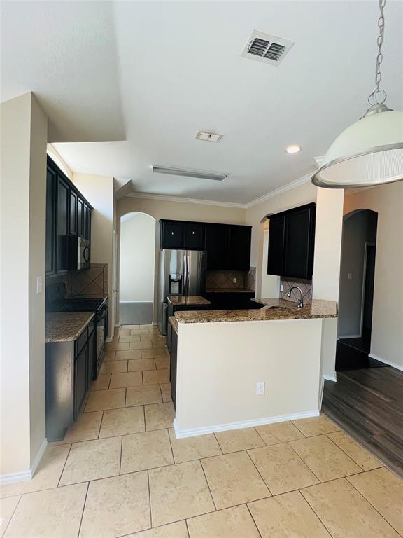 509 Trailblazer Road Forney, TX 75126 - Photo 4 of 13 a living room with stainless steel appliances furniture a kitchen view and a fireplace