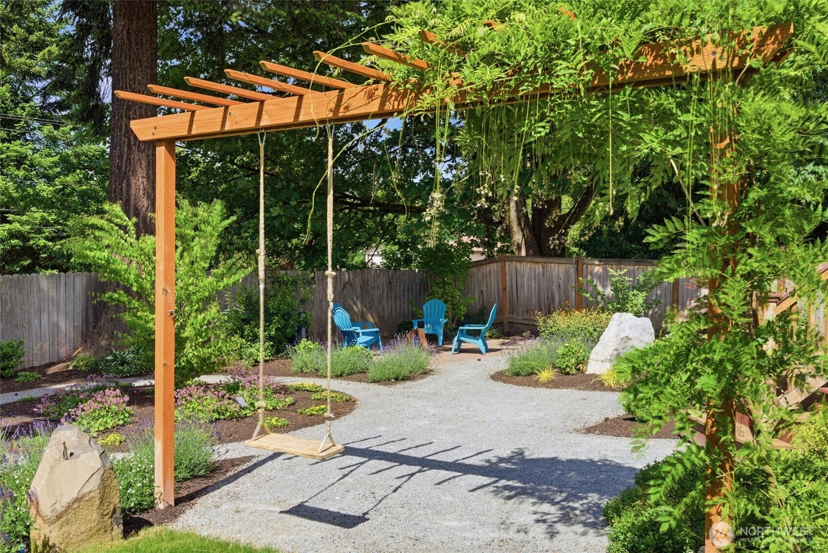 2101 233rd Street Southeast Bothell, WA 98021 - Photo 30 of 40 a backyard of a house with table and chairs a barbeque with wooden fence