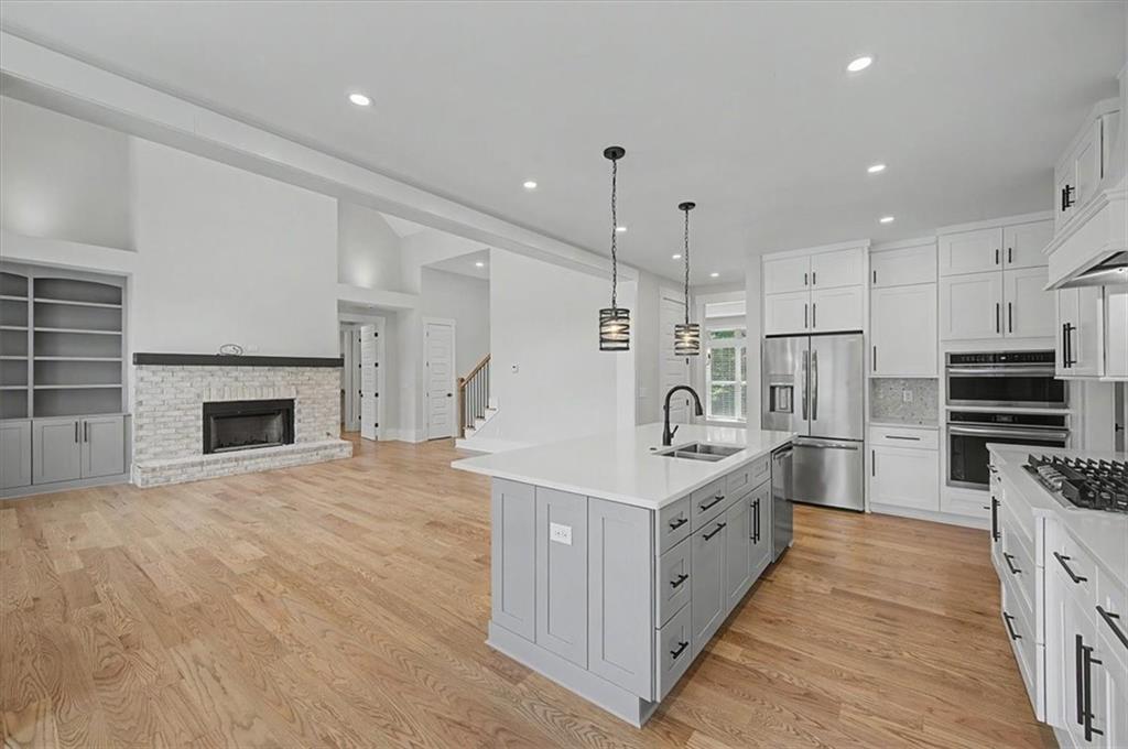 217 Laura Lake Road Marietta, GA 30066 - Photo 19 of 54 a large white kitchen with stainless steel appliances granite countertop a stove oven and a refrigerator