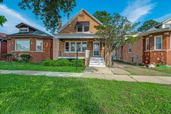 a front view of a house with a yard and porch