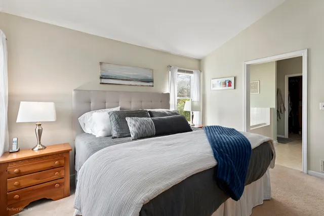 a bedroom with bed and a night stand