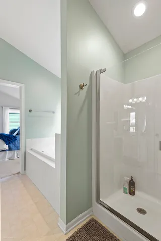 a bathroom with a bathtub and a shower