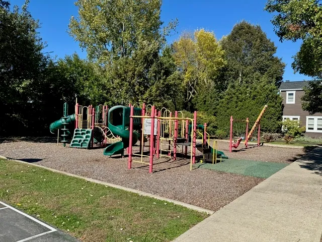 a view of grassy field with trees in the background
