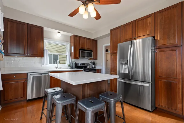 a kitchen with granite countertop a refrigerator stove top oven and sink