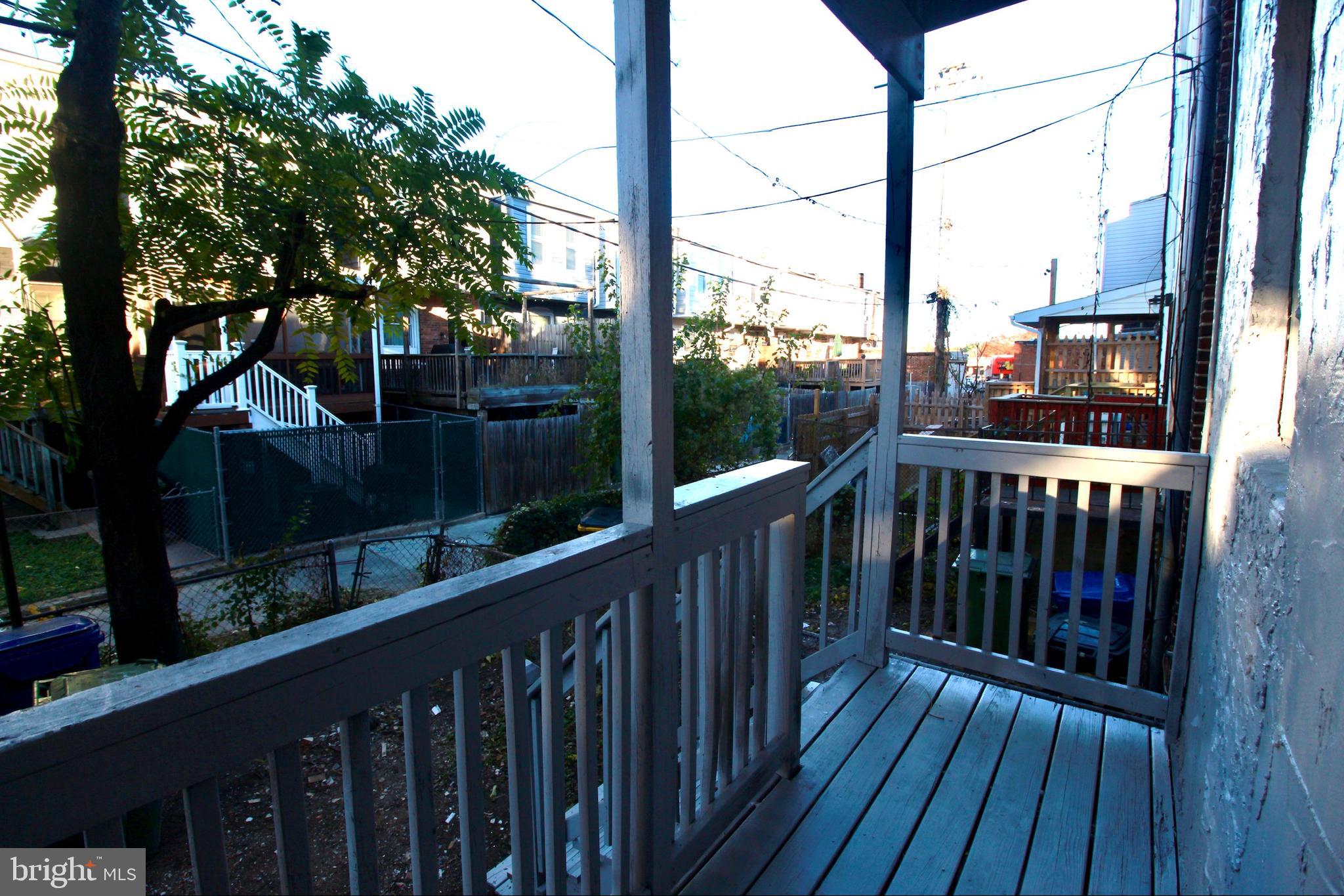 434 East 28th Street Baltimore, MD 21218 - Photo 14 of 37 a view of balcony with wooden floor and fence