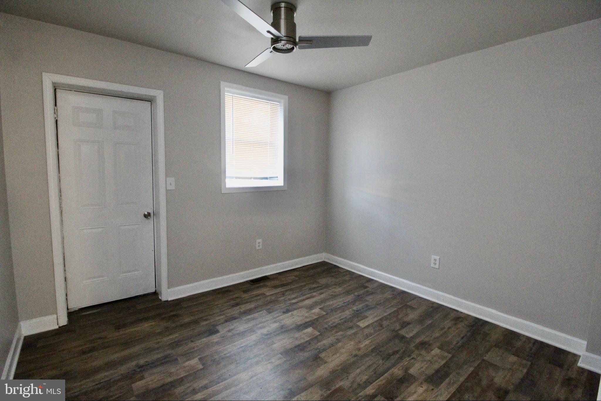434 East 28th Street Baltimore, MD 21218 - Photo 18 of 37 wooden floor in an empty room with a window