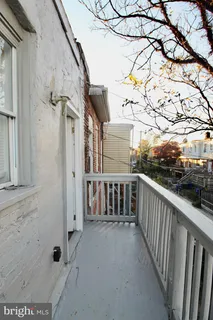 a view of a balcony with yard