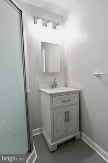 a bathroom with a sink a mirror and a vanity