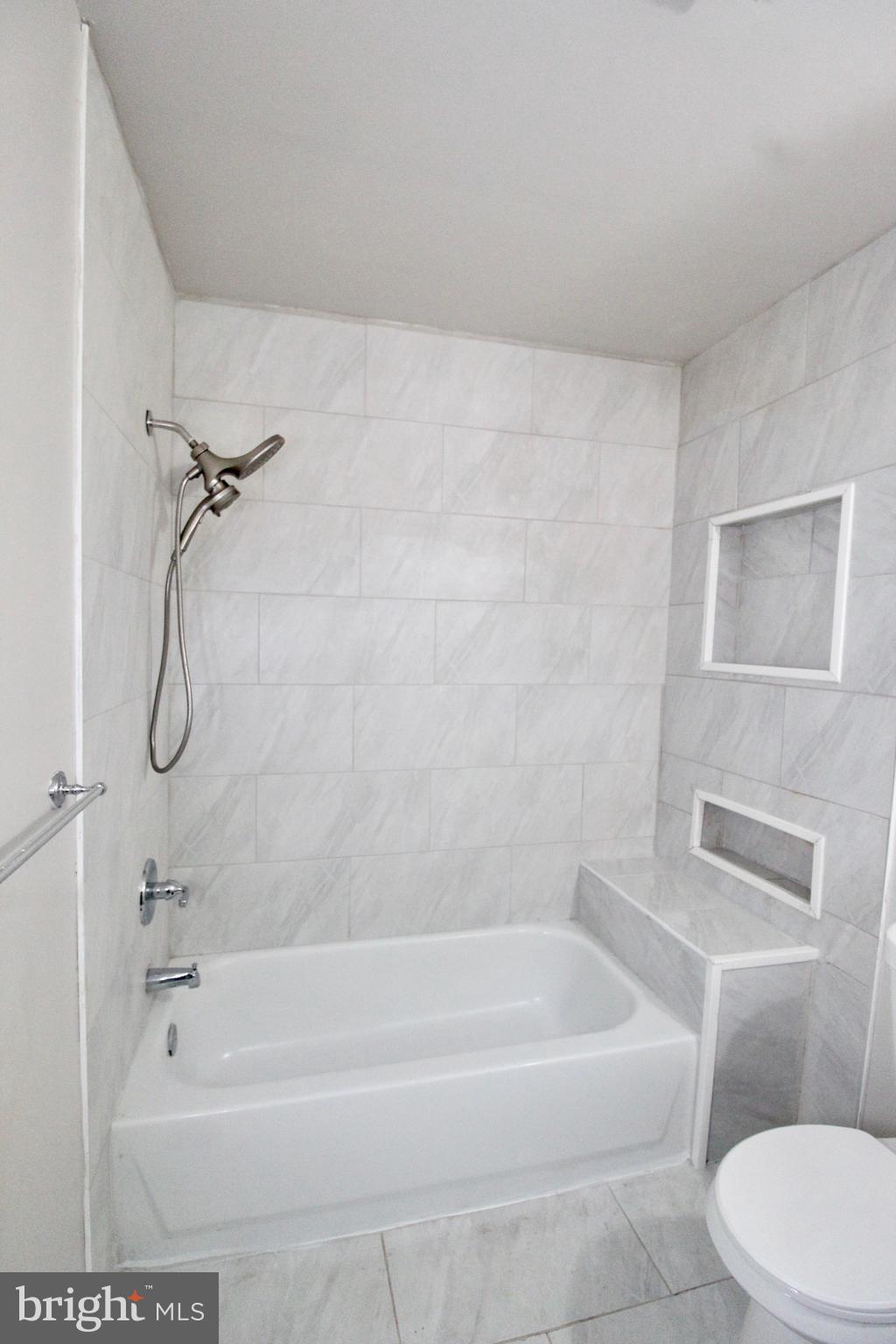 434 East 28th Street Baltimore, MD 21218 - Photo 28 of 37 a bath room with a toilet and a bath tub