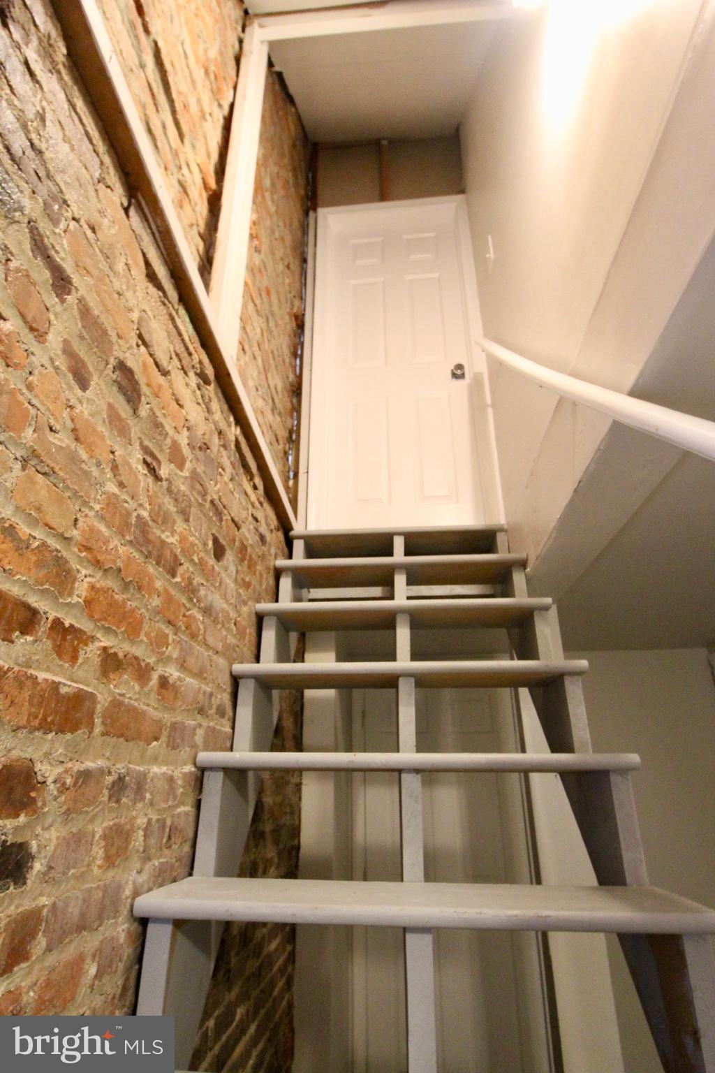 434 East 28th Street Baltimore, MD 21218 - Photo 30 of 37 a view of staircase with white walls and a window
