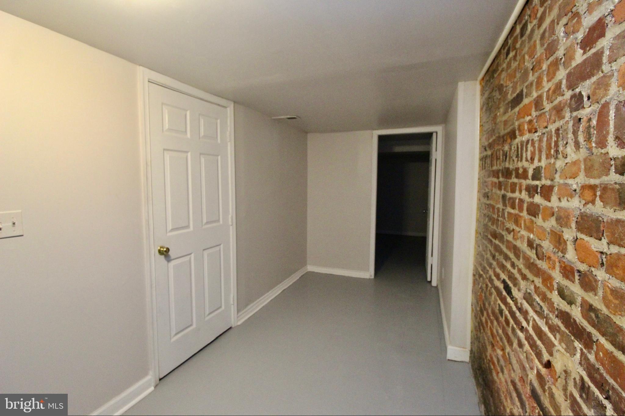 434 East 28th Street Baltimore, MD 21218 - Photo 31 of 37 a view of an empty room with wooden floor