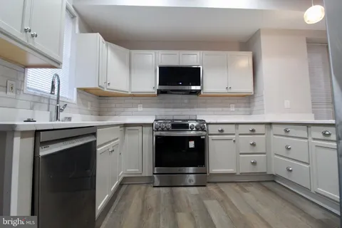 a kitchen with granite countertop a stove and a sink