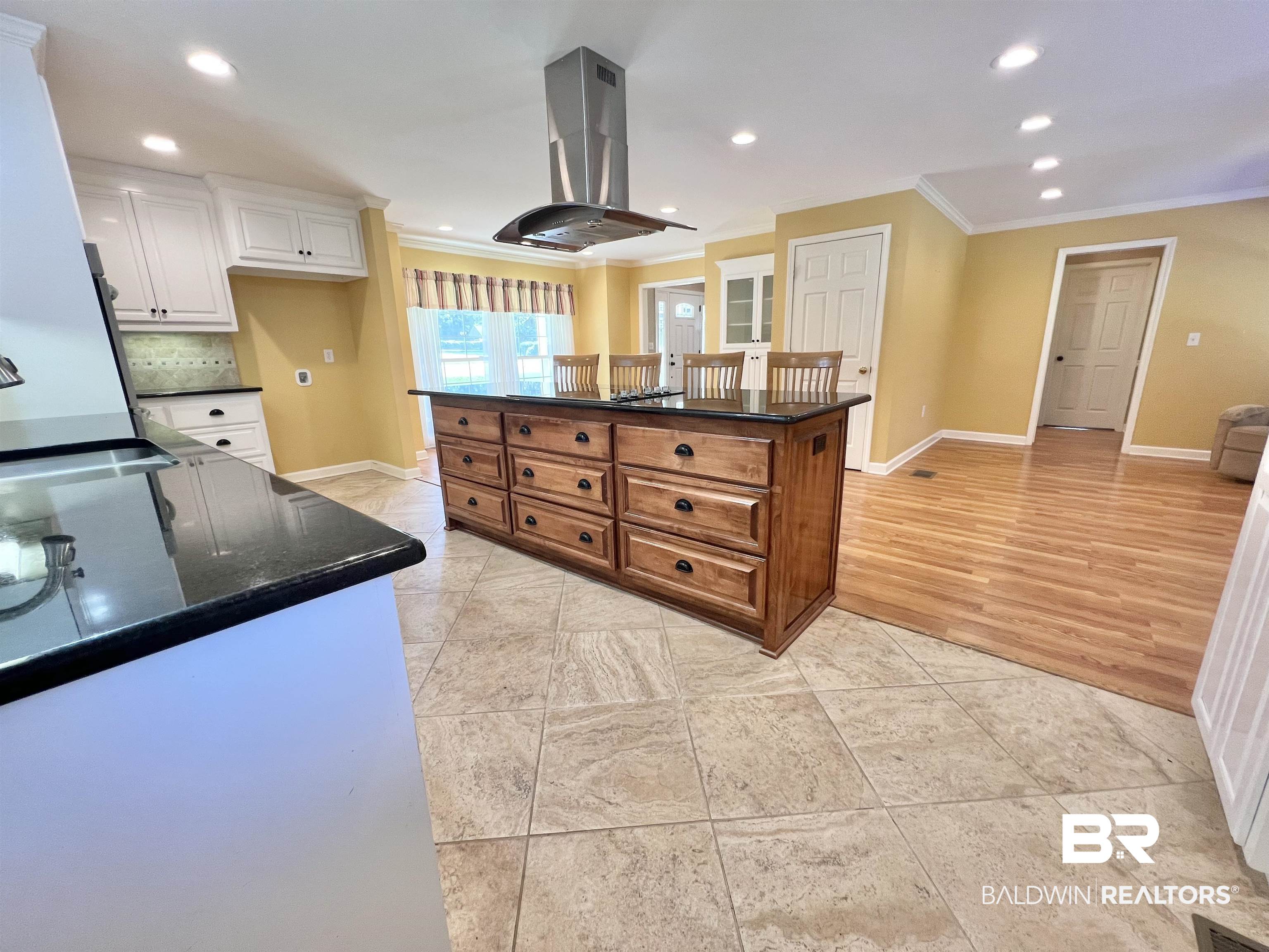 2691 Appleton Road Brewton, AL 36426 - Photo 17 of 60 Kitchen with island range hood, ornamental molding, light tile patterned flooring, recessed lighting, and dark stone counters