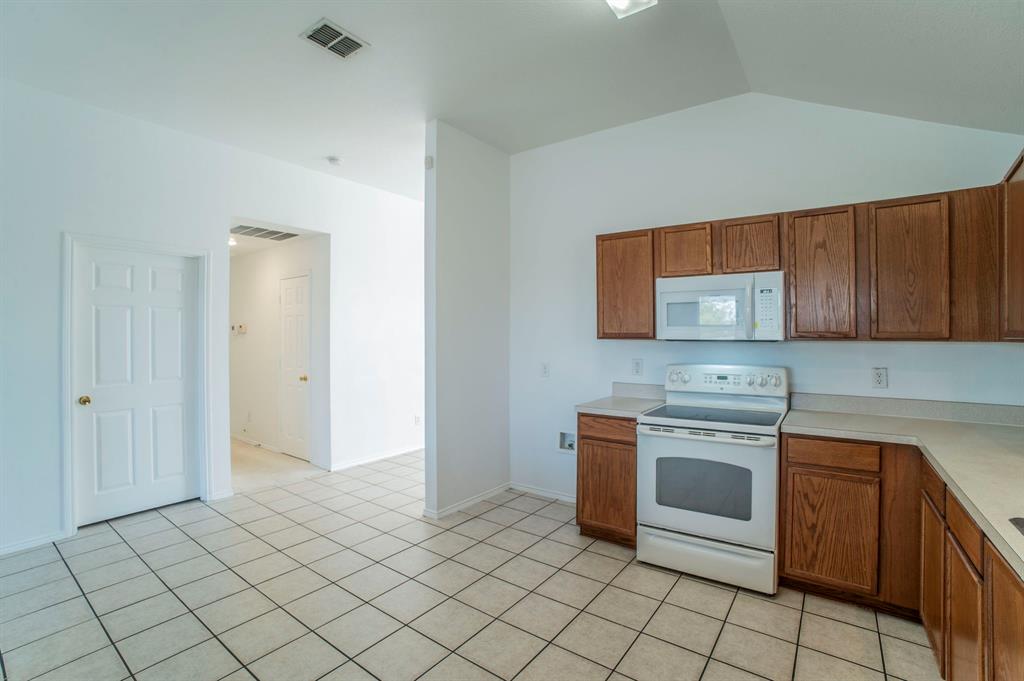 6333 Pool View Drive Dallas, TX 75249 - Photo 16 of 37 a kitchen with stainless steel appliances granite countertop a stove a sink and a microwave