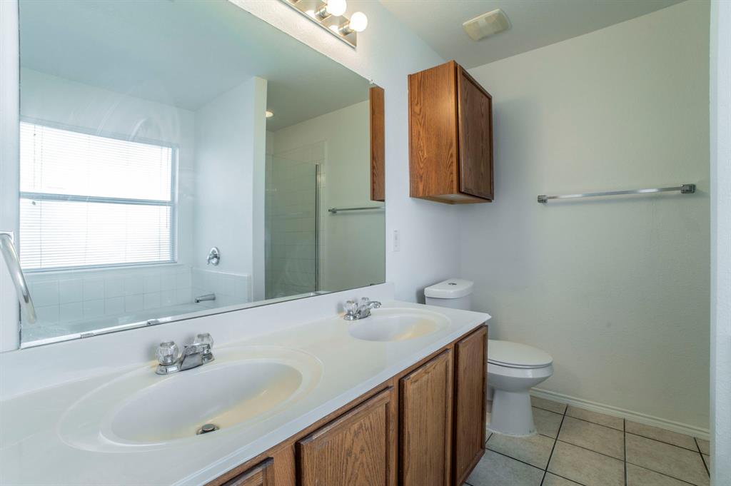 6333 Pool View Drive Dallas, TX 75249 - Photo 23 of 37 a bathroom with a sink a toilet and mirror