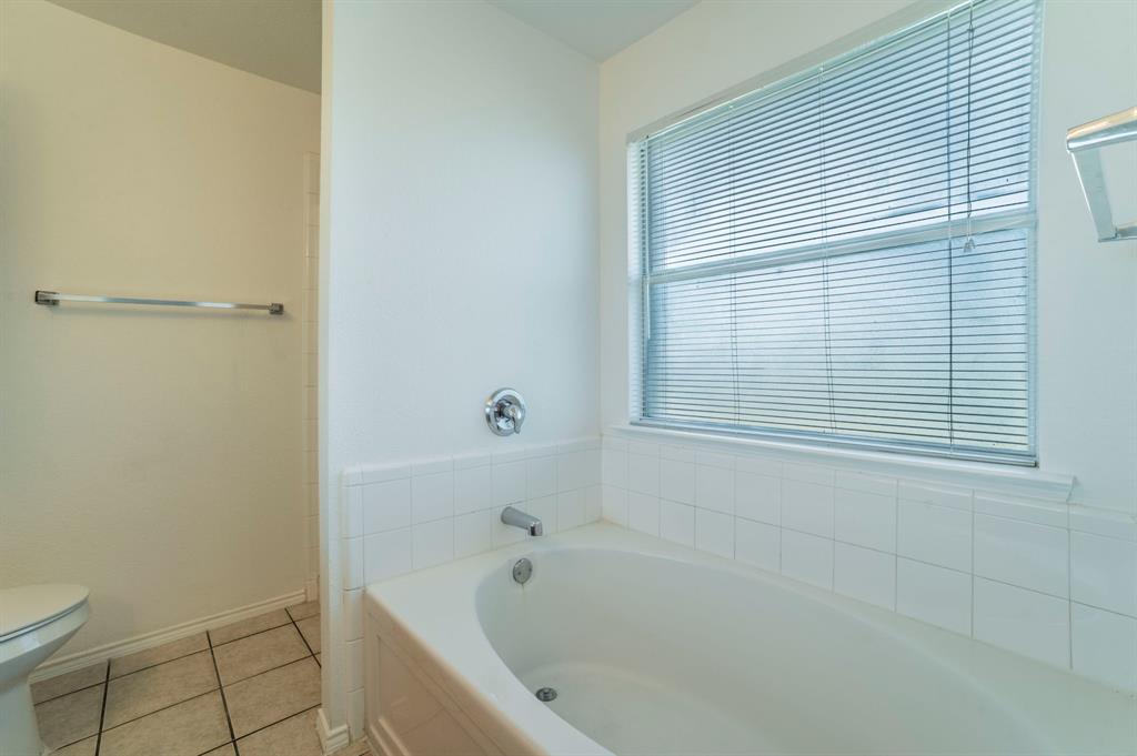 6333 Pool View Drive Dallas, TX 75249 - Photo 24 of 37 a bathroom with a bathtub and toilet