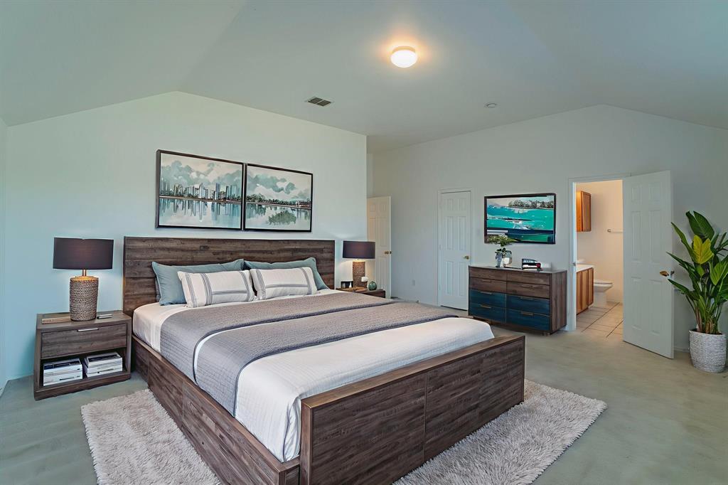 6333 Pool View Drive Dallas, TX 75249 - Photo 6 of 37 a bedroom with a bed and a potted plant