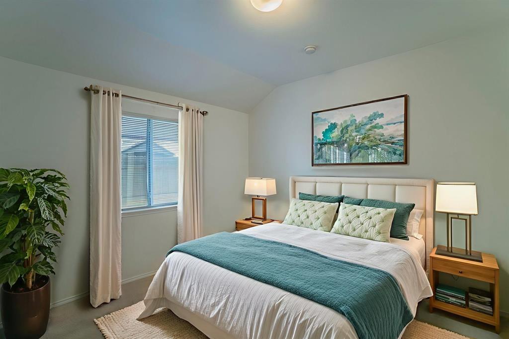 6333 Pool View Drive Dallas, TX 75249 - Photo 8 of 37 a bedroom with a large bed and a potted plant