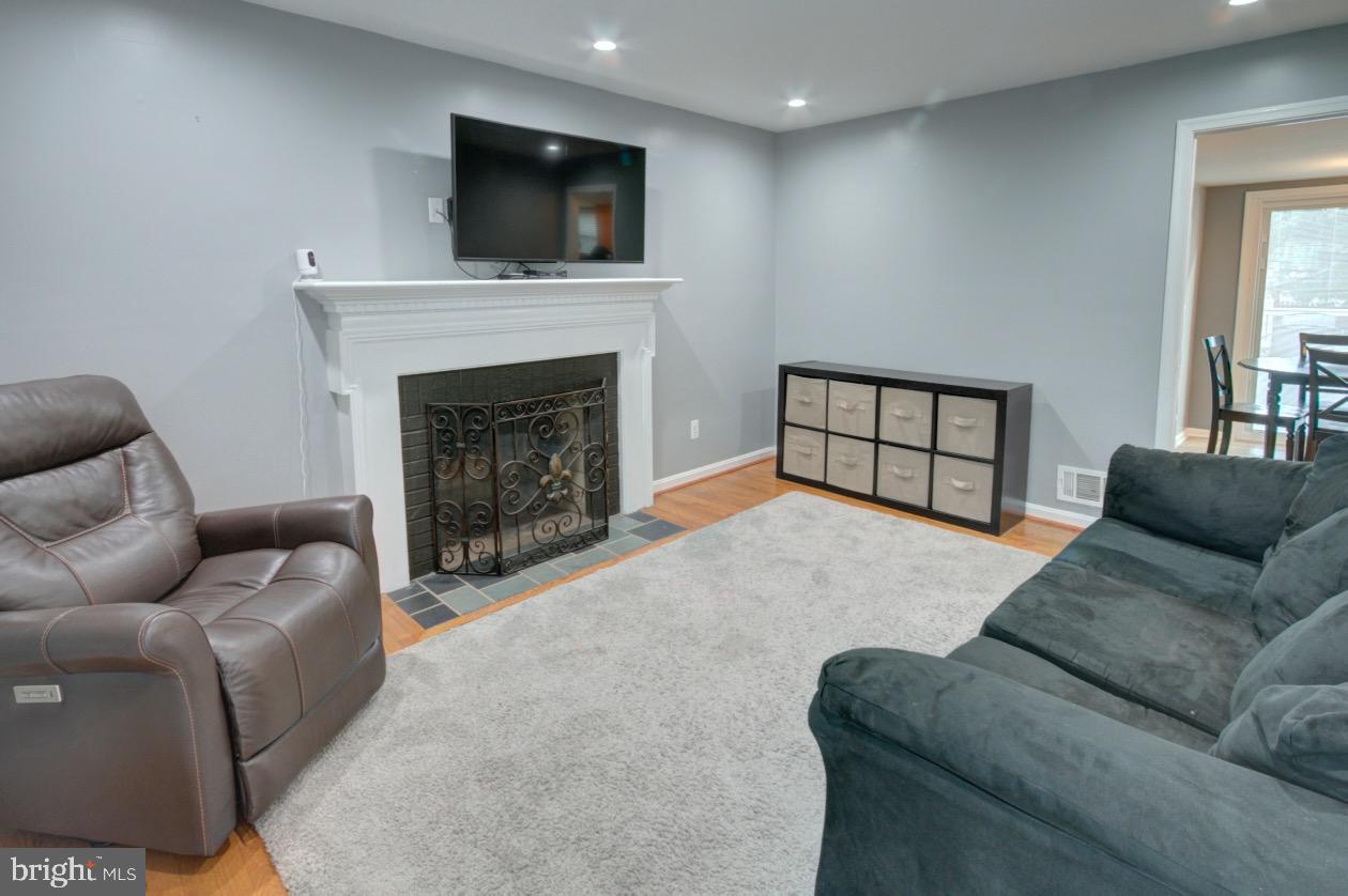 9015 Horton Road Laurel, MD 20708 - Photo 13 of 33 a living room with furniture a flat screen tv and a fireplace