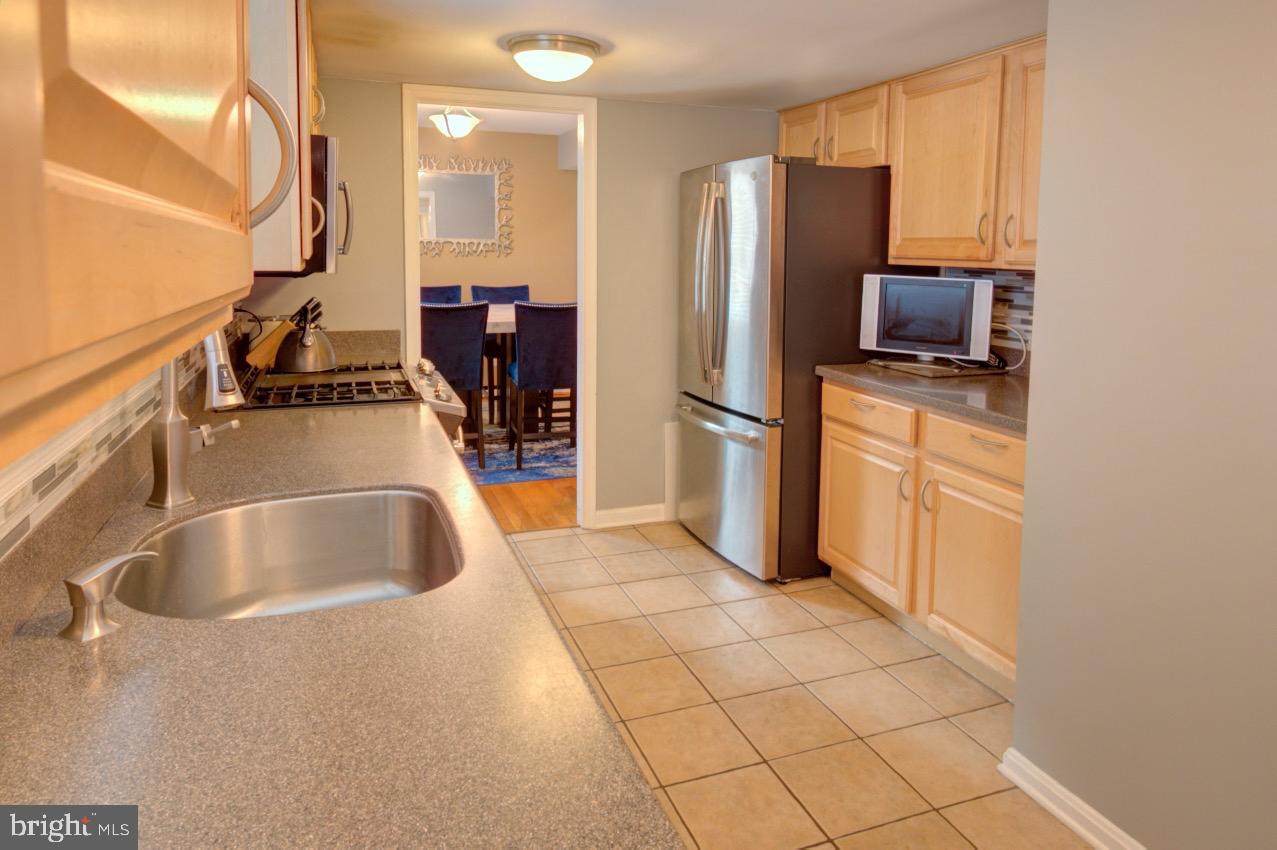 9015 Horton Road Laurel, MD 20708 - Photo 15 of 33 a kitchen with stainless steel appliances granite countertop a refrigerator and a sink