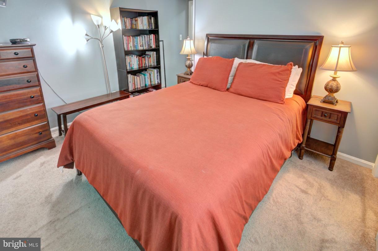 9015 Horton Road Laurel, MD 20708 - Photo 24 of 33 a large bed sitting in a bedroom next to a book shelf