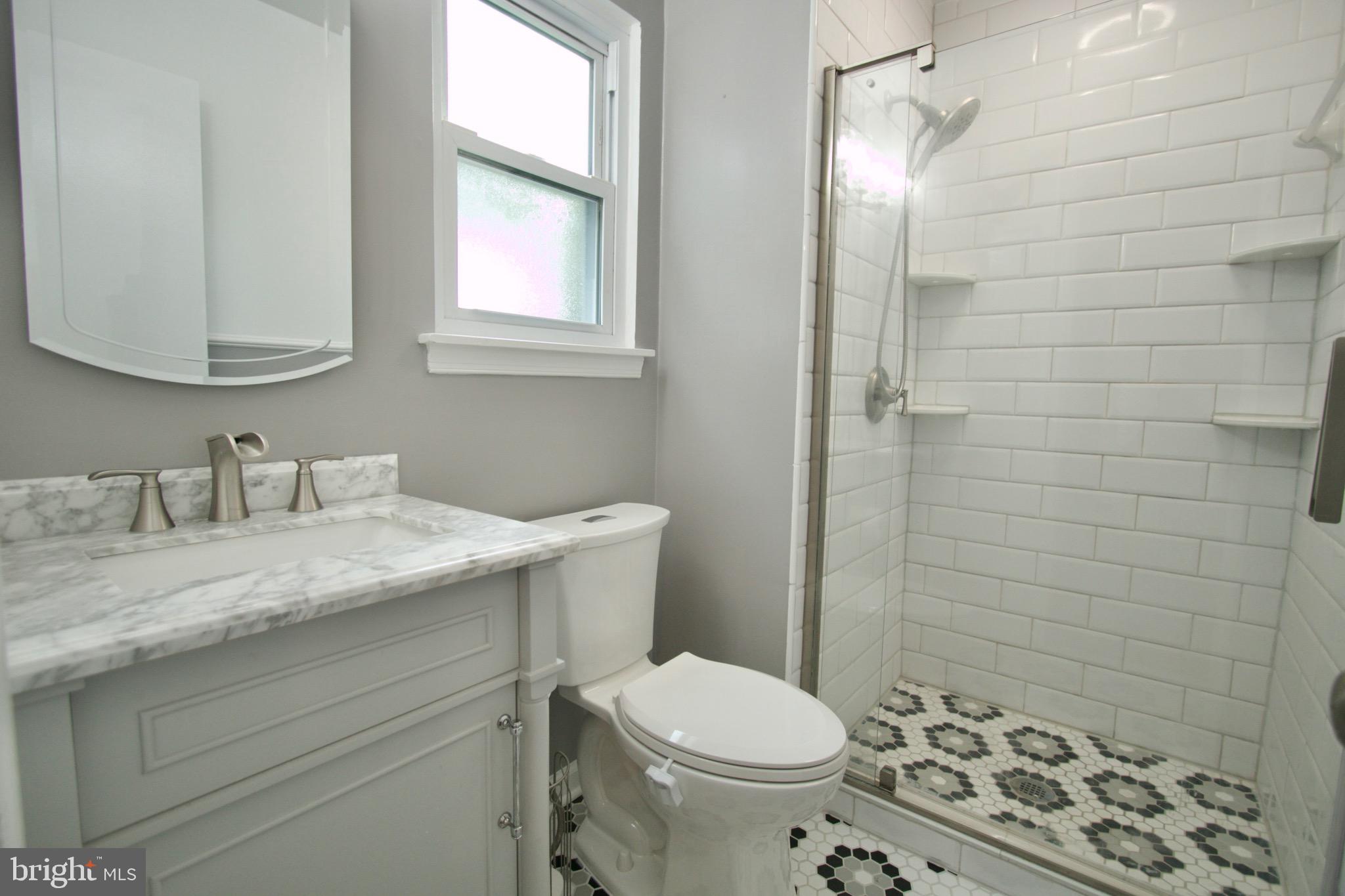 9015 Horton Road Laurel, MD 20708 - Photo 28 of 33 a bathroom with a granite countertop sink toilet and shower