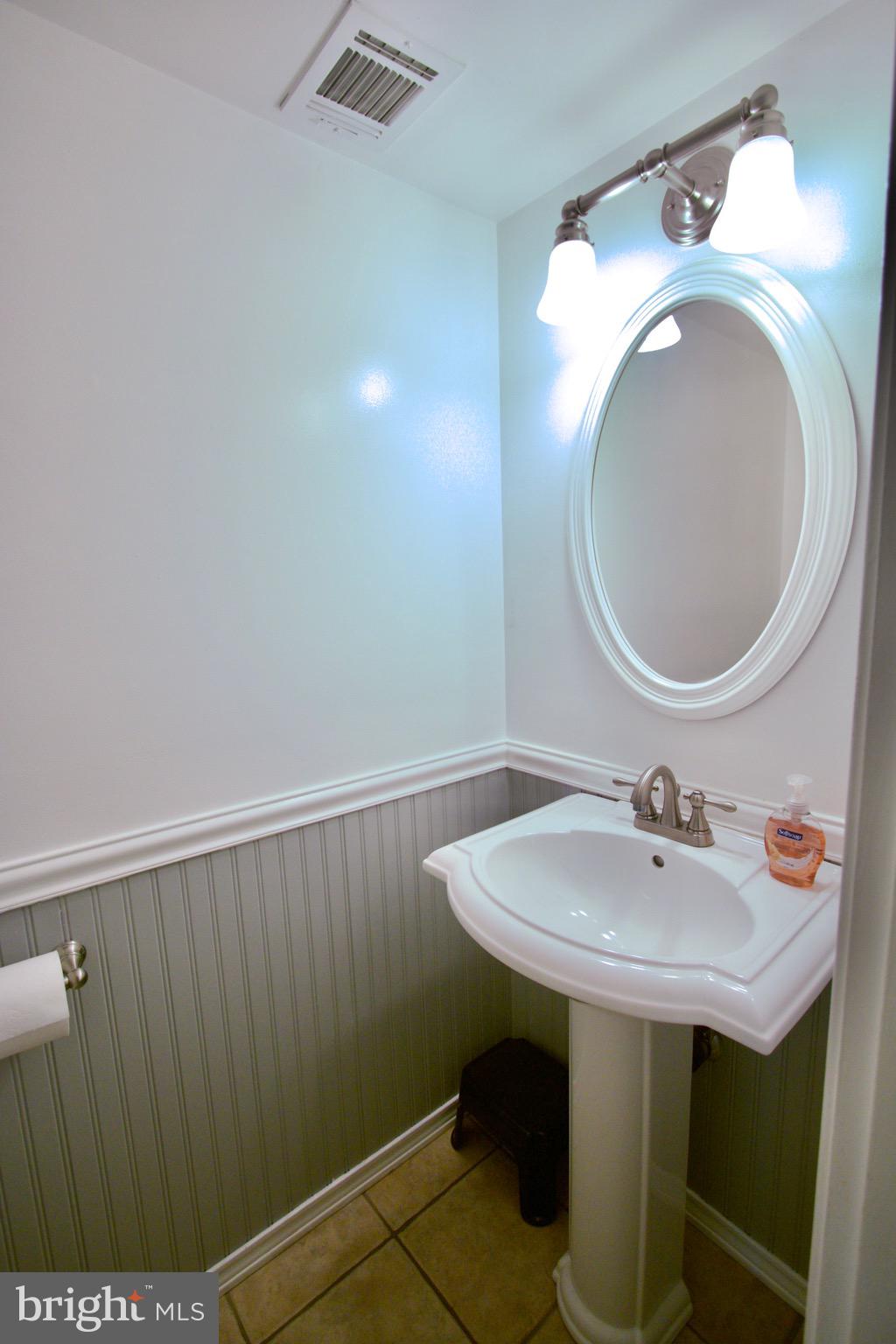 9015 Horton Road Laurel, MD 20708 - Photo 30 of 33 a bathroom with a sink a toilet and a mirror