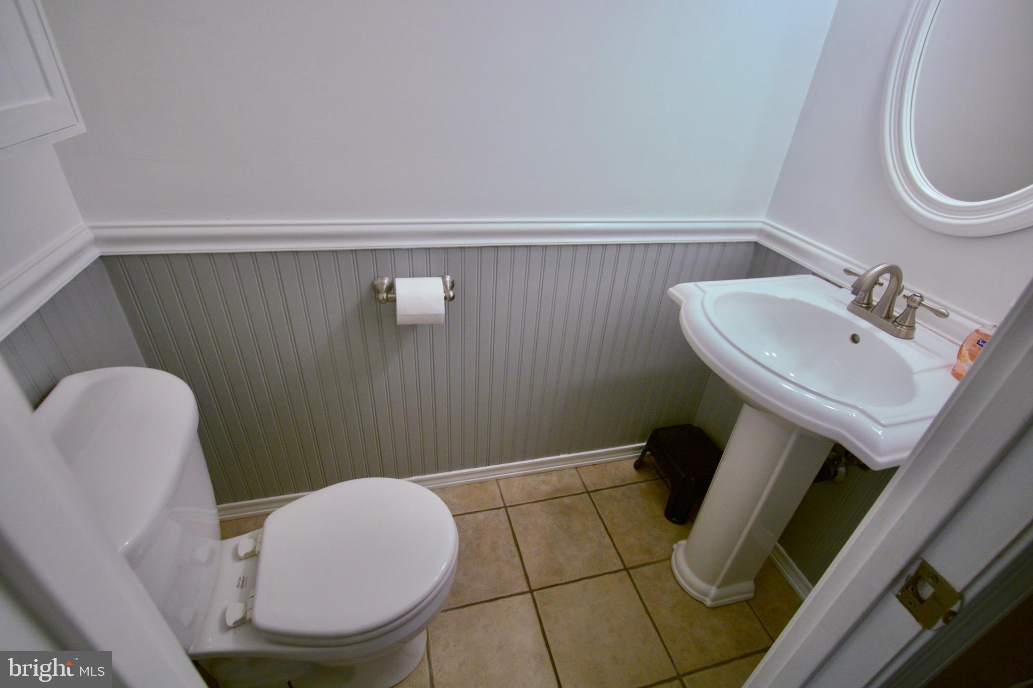 9015 Horton Road Laurel, MD 20708 - Photo 31 of 33 a bathroom with a sink toilet and a mirror