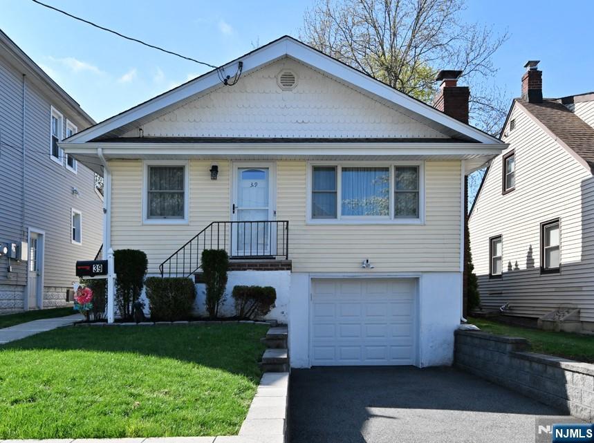 39 Niagara Street Dumont, NJ 07628 - Photo 1 of 40 a front view of a house with a yard
