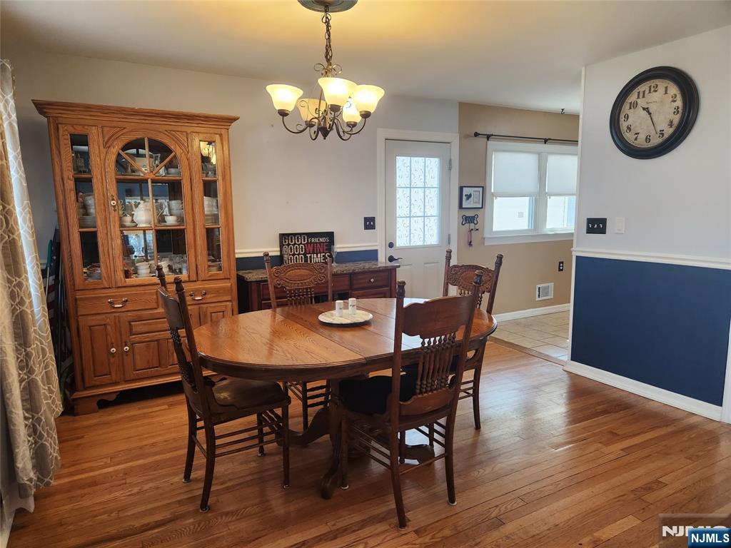 39 Niagara Street Dumont, NJ 07628 - Photo 11 of 40 a view of a dining room with furniture a chandelier and wooden floor