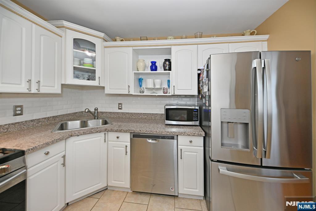 39 Niagara Street Dumont, NJ 07628 - Photo 12 of 40 a kitchen with a sink and refrigerator