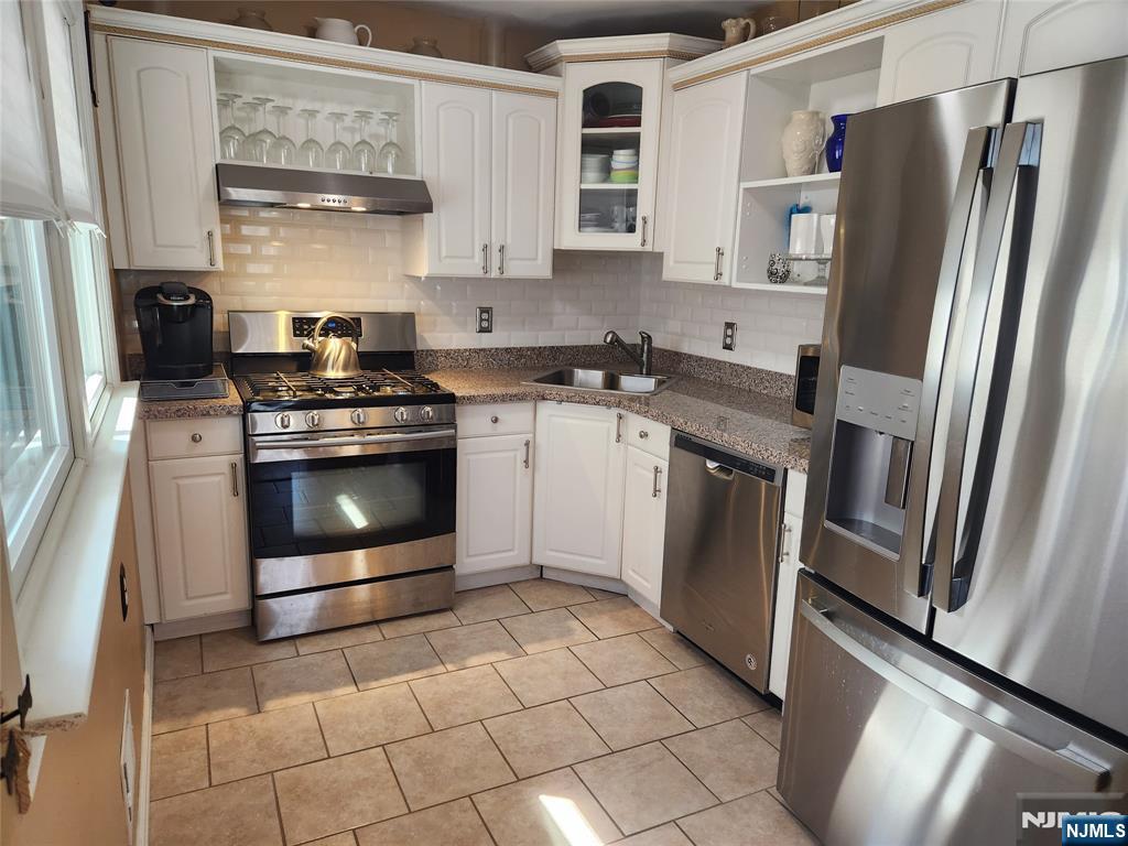 39 Niagara Street Dumont, NJ 07628 - Photo 13 of 40 a kitchen with a stove microwave and refrigerator