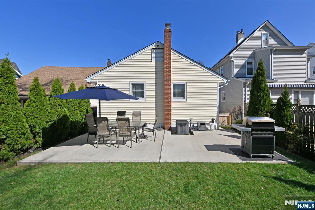 39 Niagara Street Dumont, NJ 07628 - Photo 23 of 40 a view of a patio with table and chairs under an umbrella