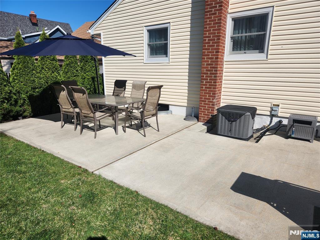 39 Niagara Street Dumont, NJ 07628 - Photo 28 of 40 a view of a patio with table and chairs under an umbrella
