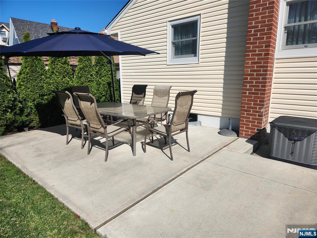39 Niagara Street Dumont, NJ 07628 - Photo 30 of 40 a roof deck with table and chairs under an umbrella