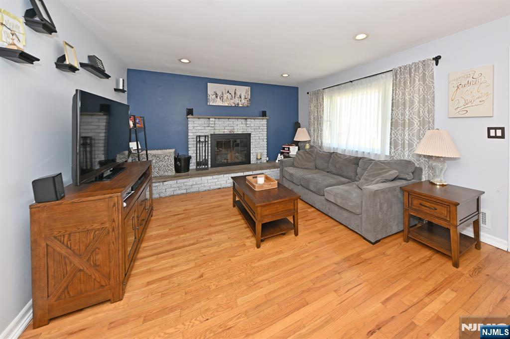 39 Niagara Street Dumont, NJ 07628 - Photo 5 of 40 a living room with furniture a flat screen tv and a fireplace