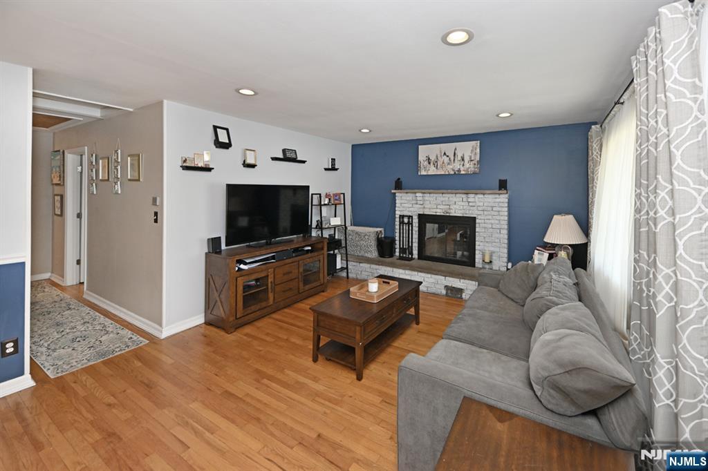 39 Niagara Street Dumont, NJ 07628 - Photo 6 of 40 a living room with furniture a flat screen tv and a fireplace