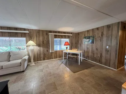 a living room with furniture a window and a table