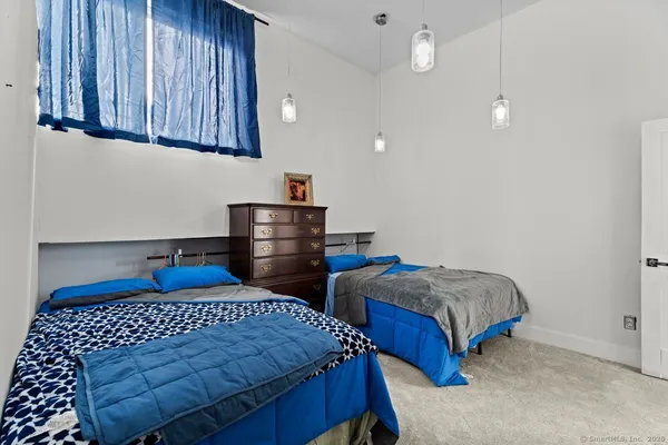 a bedroom with two beds and painted walls