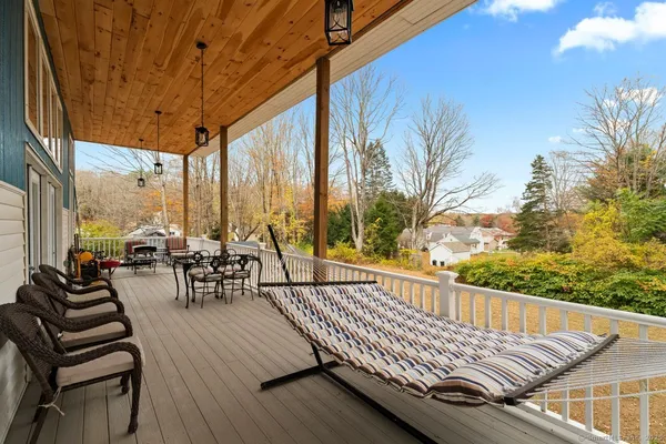 a view of balcony with chairs and wooden fence