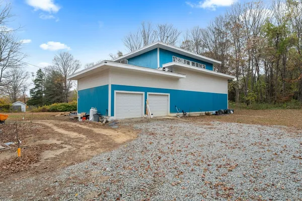 a view of a house with a yard and garage