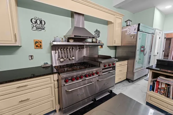 a kitchen with stainless steel appliances a stove a refrigerator and cabinets