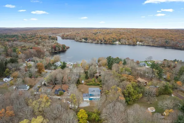 an aerial view of a houses with a lake