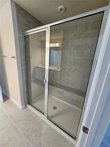 a bathroom with a glass shower door