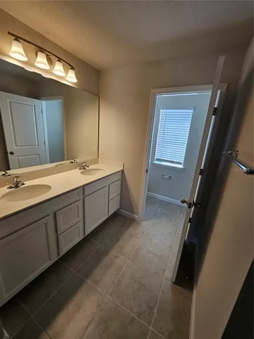 a room with a sink and a mirror