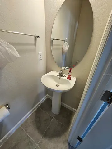 a bathroom with a sink a mirror and a shower