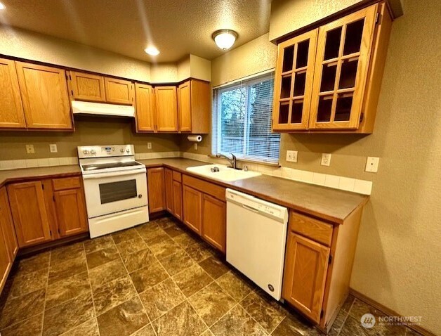 3419 Bittersweet Street Southeast Olympia, WA 98501 - Photo 4 of 15 a kitchen with a stove sink and cabinets