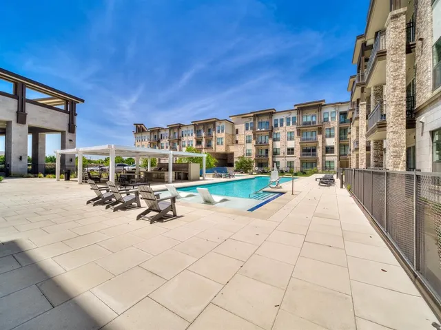 a view of a patio with swimming pool table and chairs