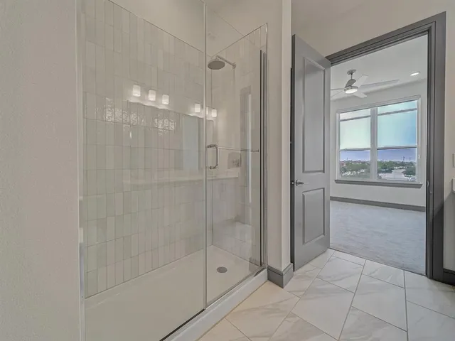 a spacious bathroom with a granite countertop sink and a mirror