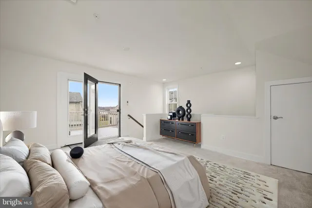 a bedroom with a bed and a large mirror